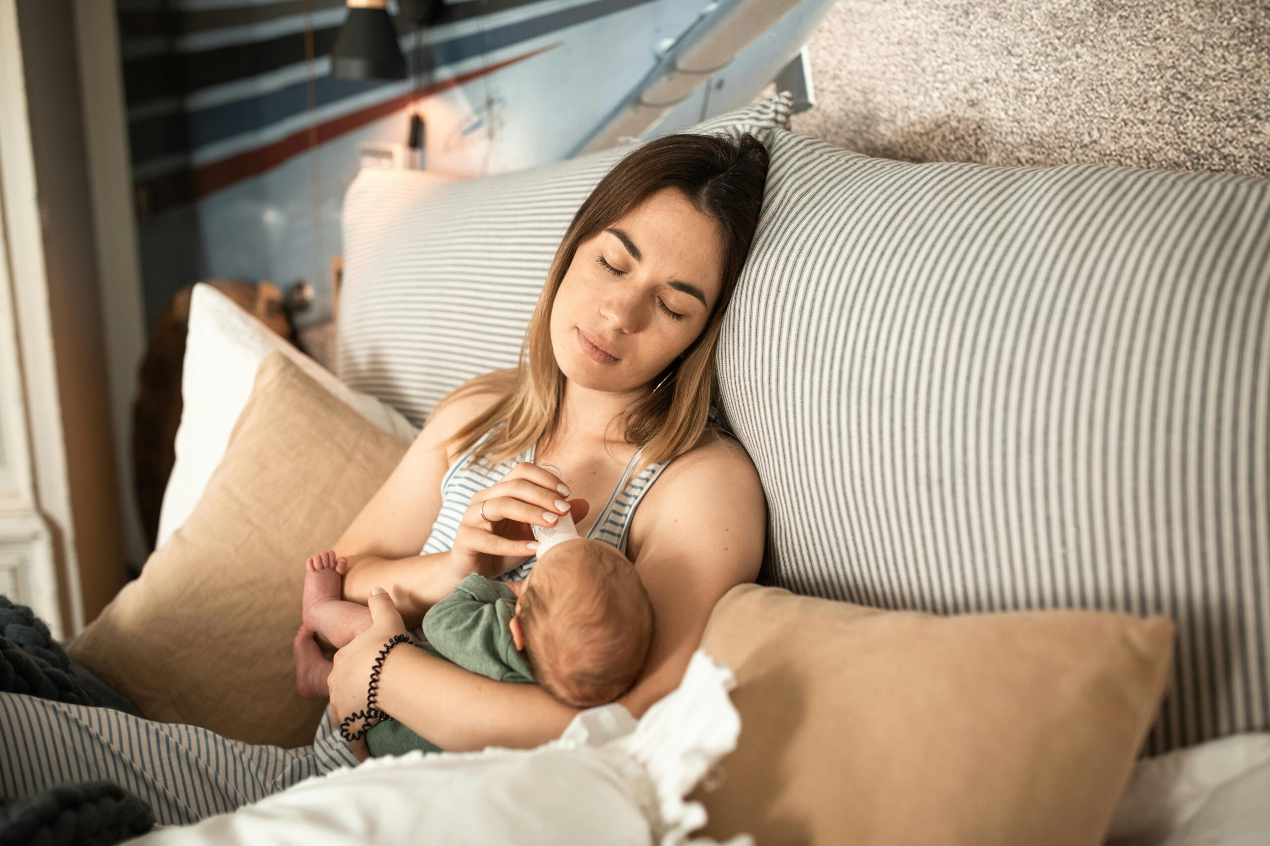 Peaceful moment of a mother and newborn baby relaxing at home.